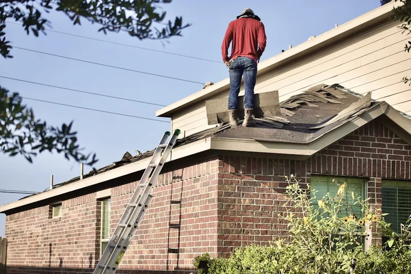 Professional roofer working on a residential roof in Linwood
